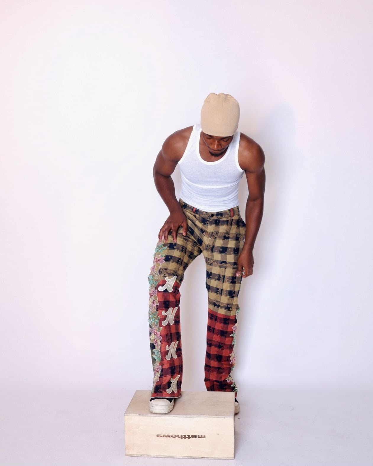 Mannequin wearing a white tank top and plaid pants on a white background